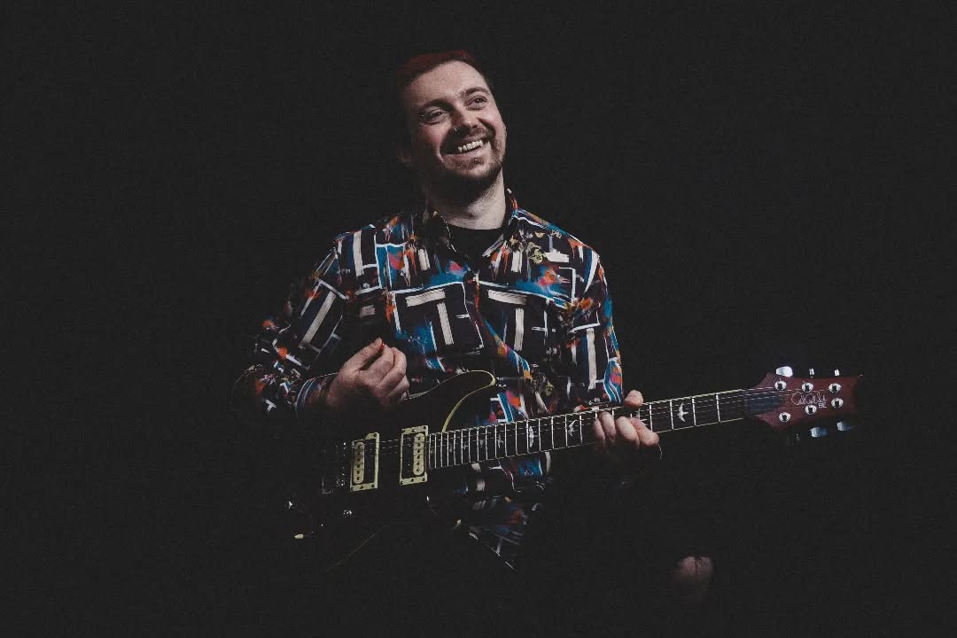 Guitarist with PRS guitar